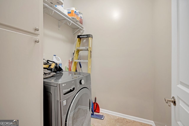 washroom featuring washer / dryer and light tile patterned floors