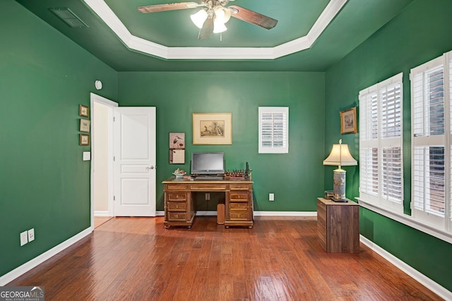 office space featuring a tray ceiling, ceiling fan, and dark wood-type flooring