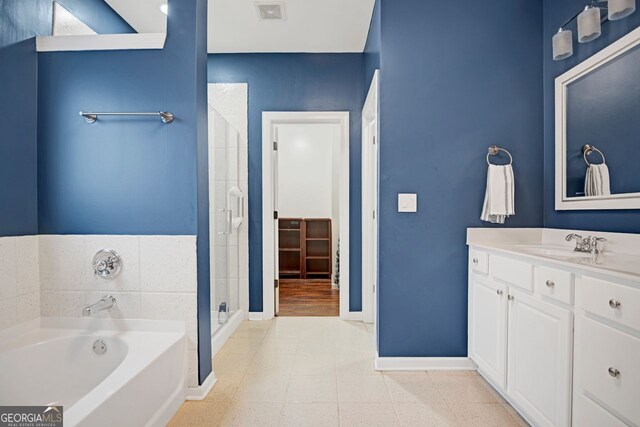 bathroom with shower with separate bathtub and vanity