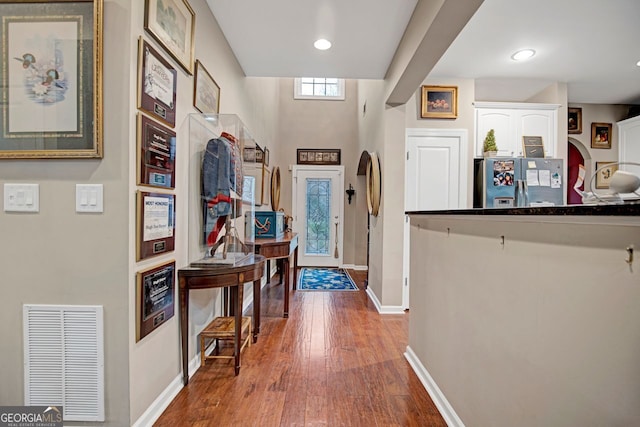 hallway with hardwood / wood-style flooring