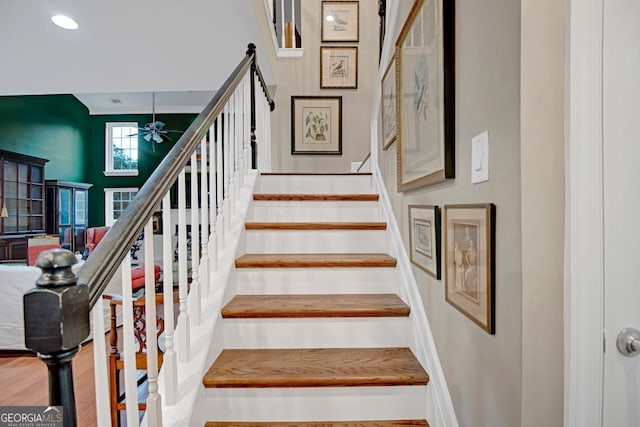 stairs with ceiling fan and wood-type flooring