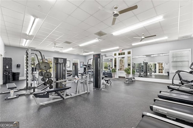 exercise room with a drop ceiling and ceiling fan