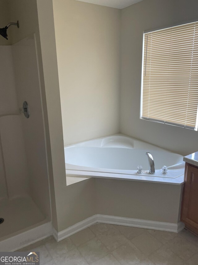 bathroom with vanity and plus walk in shower