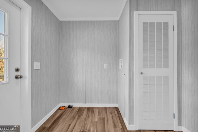 clothes washing area with wood-type flooring