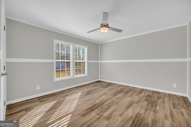 unfurnished room featuring ceiling fan, light hardwood / wood-style flooring, and ornamental molding