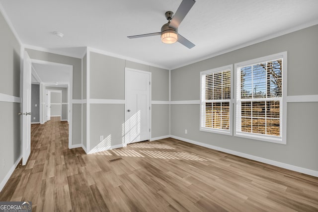 empty room with light wood-type flooring and ceiling fan