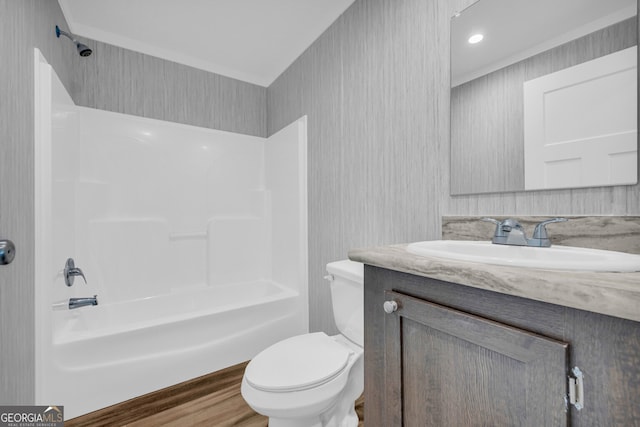 full bathroom featuring vanity, crown molding, hardwood / wood-style flooring, toilet, and shower / bath combination