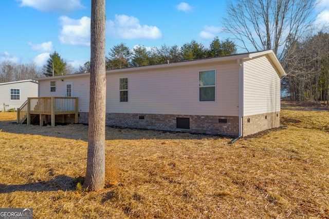 view of home's exterior with a wooden deck