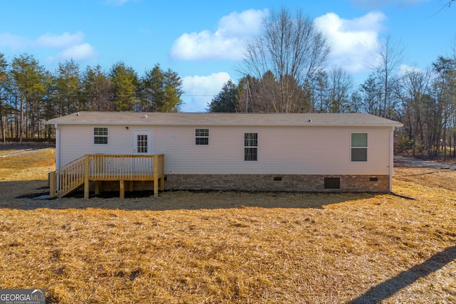 rear view of property with a yard and a deck