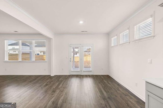 interior space featuring ornamental molding and dark hardwood / wood-style floors