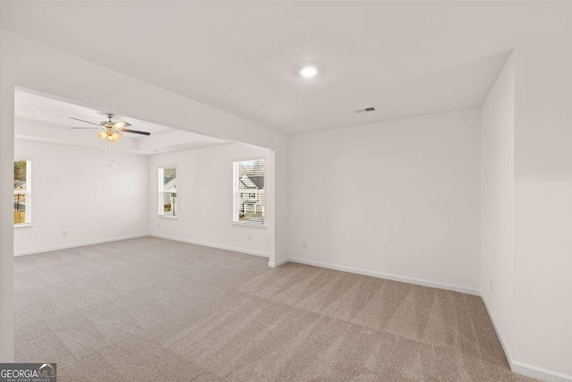 unfurnished room featuring light colored carpet and ceiling fan