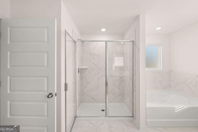 bathroom with separate shower and tub