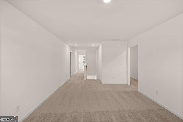 unfurnished room with light carpet