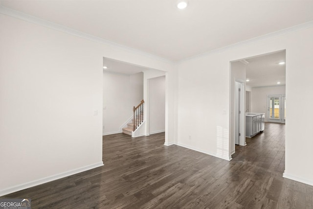 unfurnished room with sink, ornamental molding, and dark wood-type flooring