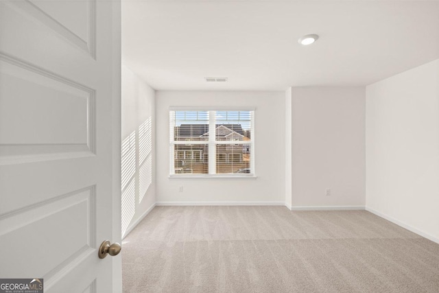 unfurnished room with light colored carpet