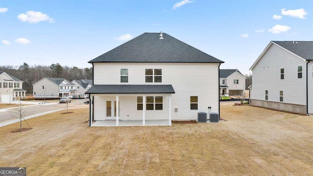 rear view of house with central air condition unit and a patio