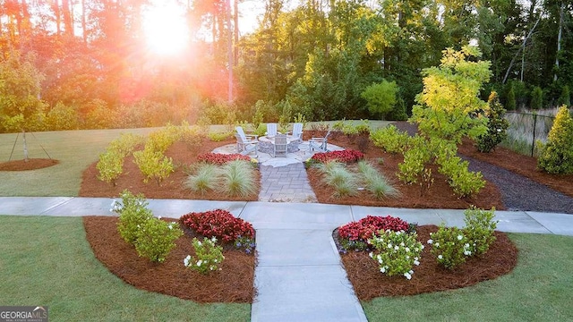 yard at dusk with a patio and an outdoor fire pit