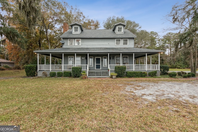 farmhouse inspired home with a porch and a front lawn