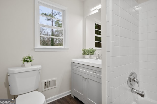 bathroom featuring hardwood / wood-style flooring, vanity, and toilet