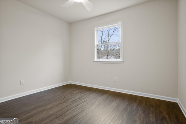 spare room with dark hardwood / wood-style floors and ceiling fan