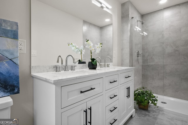 bathroom featuring vanity and a tile shower