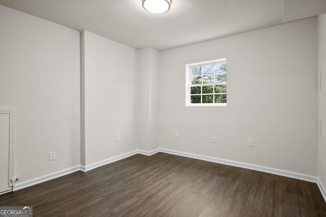 spare room featuring dark hardwood / wood-style flooring