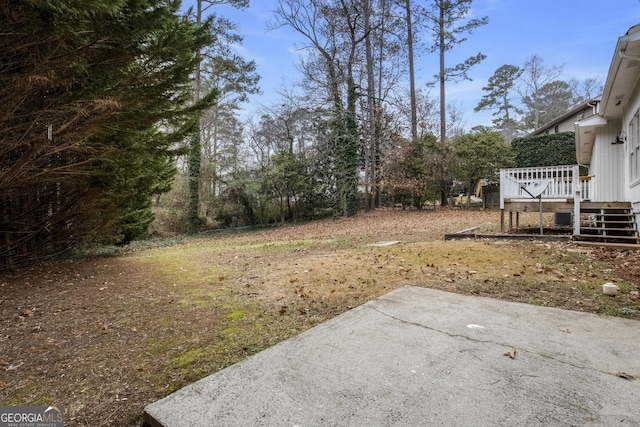 view of yard featuring a deck and a patio