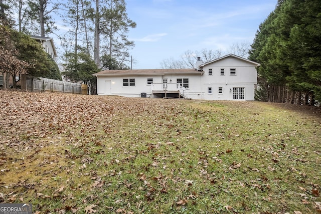 back of property with a lawn