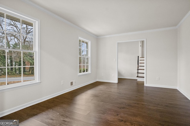 spare room featuring dark hardwood / wood-style flooring and ornamental molding