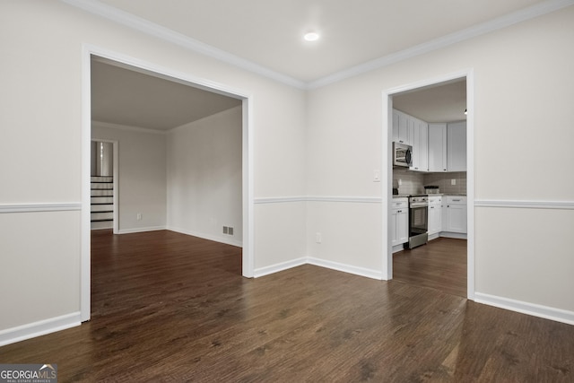 unfurnished room featuring dark hardwood / wood-style floors and ornamental molding