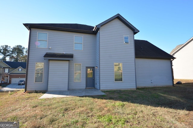 rear view of house featuring a yard and a patio