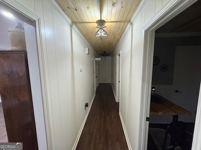 hallway featuring dark hardwood / wood-style floors and wood ceiling