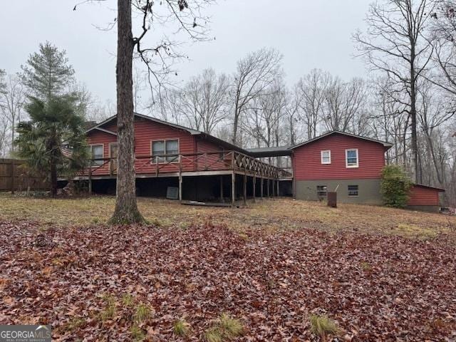 back of property with a wooden deck