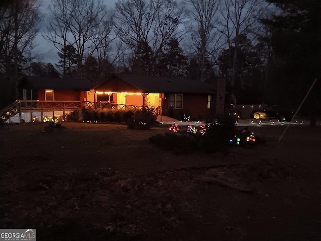 view of back house at twilight