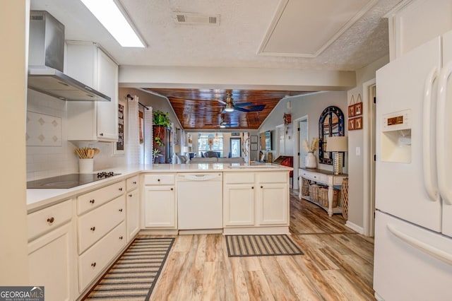 kitchen featuring kitchen peninsula, white appliances, ceiling fan, wall chimney range hood, and wooden ceiling