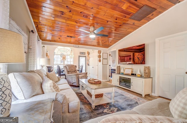 living room with light hardwood / wood-style flooring, ceiling fan, lofted ceiling, and wood ceiling