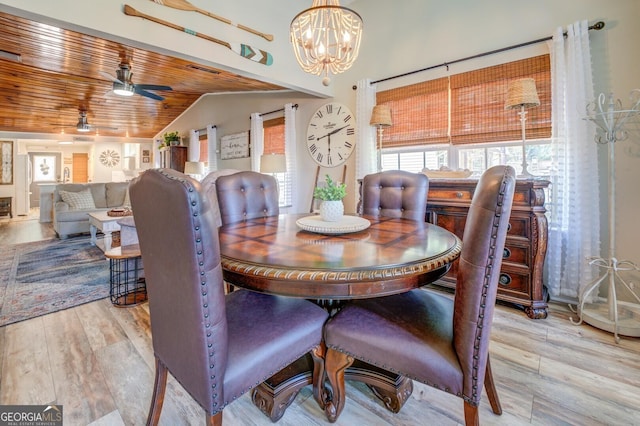 dining room with ceiling fan with notable chandelier, wooden ceiling, lofted ceiling, and light wood-type flooring