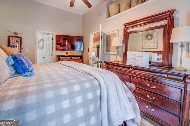 bedroom with ceiling fan, crown molding, and a towering ceiling