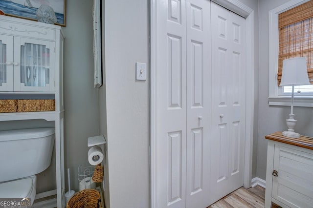 interior space featuring toilet and wood-type flooring