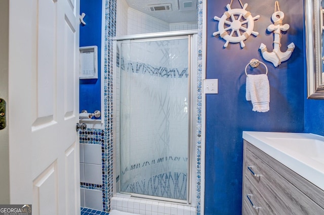 bathroom featuring vanity and a shower with door