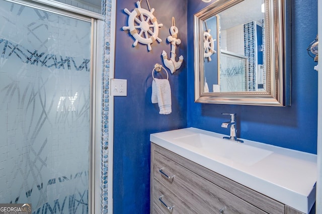 bathroom featuring vanity and a shower with shower door