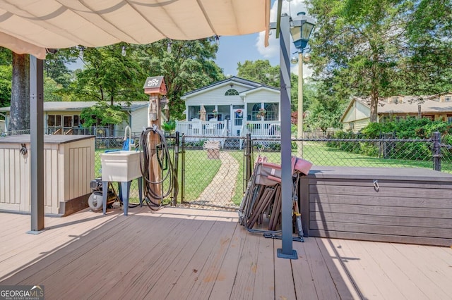 wooden terrace featuring a lawn