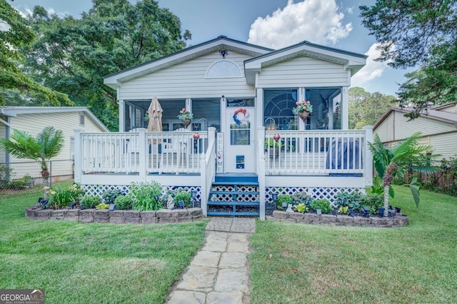 bungalow-style house with a porch and a front lawn