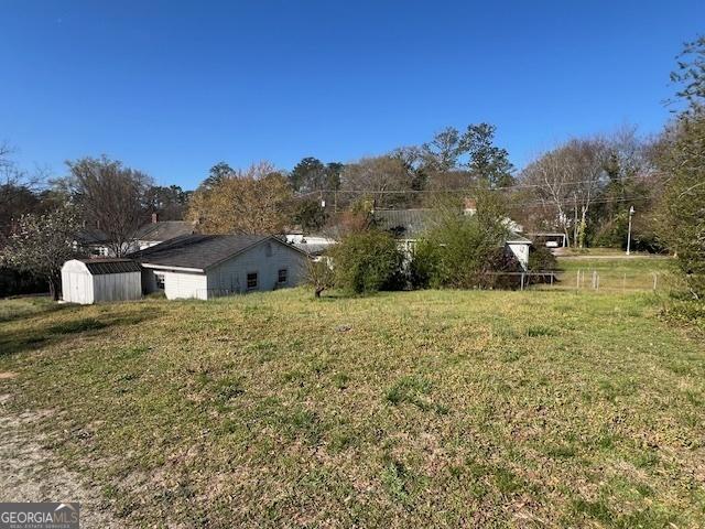 view of yard with a storage shed and an outdoor structure