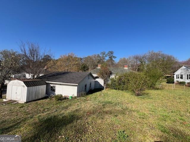 view of yard with an outbuilding and a shed