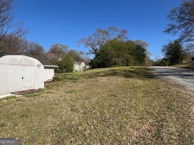 view of yard with an outbuilding and a shed