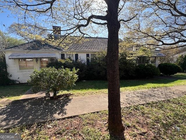 view of front of home featuring a chimney