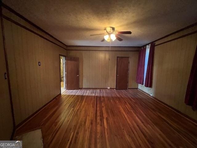 unfurnished bedroom featuring wood walls and wood finished floors