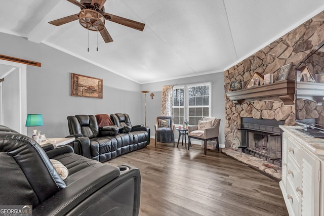 living room with a fireplace, vaulted ceiling, ceiling fan, and dark wood-type flooring