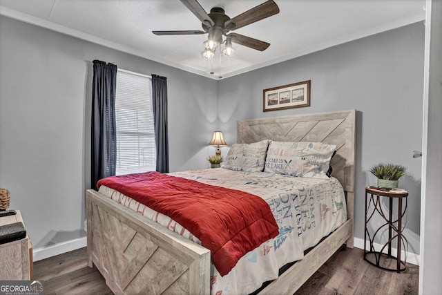 bedroom featuring ceiling fan, dark hardwood / wood-style flooring, and ornamental molding